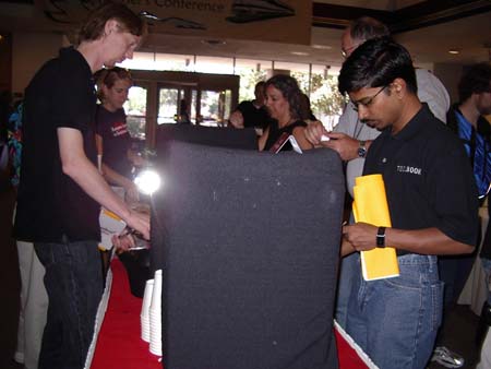 Ole Hartvigsen, Kimberly Koester, a shiny object, an attendee, John Chapman (obscurred) and Vishal Singh