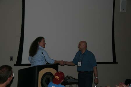 Mauro Rech receiving the "Best Native ToolBook Appplication" award from Katharine Opincarne of SumTotal Systems.